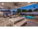 Backyard oasis featuring a covered patio with dining, a sparkling pool with a waterfall, and lush landscaping at 3401 N 34Th Pl, Phoenix, AZ 85018