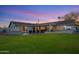 Expansive backyard showcasing a sparkling pool, covered patio, and lush green lawn, perfect for outdoor enjoyment at 3401 N 34Th Pl, Phoenix, AZ 85018