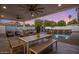 Picturesque backyard patio with dining and lounge areas, offering stunning views of the pool and lush landscaping at 3401 N 34Th Pl, Phoenix, AZ 85018