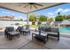 Relaxing backyard patio featuring comfortable seating, a built-in grill, and a picturesque view of the sparkling pool at 3401 N 34Th Pl, Phoenix, AZ 85018