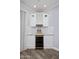 Modern bar with wine fridge, custom shelving, and stone countertops at 3401 N 34Th Pl, Phoenix, AZ 85018