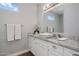 Bright bathroom with marble countertop, white vanity, and modern fixtures at 3401 N 34Th Pl, Phoenix, AZ 85018