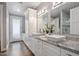Bright bathroom featuring double sinks, elegant marble counters, and modern lighting at 3401 N 34Th Pl, Phoenix, AZ 85018
