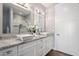 Bathroom featuring double vanity sinks, modern lighting, and a separate toilet room at 3401 N 34Th Pl, Phoenix, AZ 85018