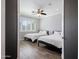 Bedroom featuring two beds, plantation shutters and wood-style tile flooring at 3401 N 34Th Pl, Phoenix, AZ 85018