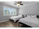Bedroom with two beds, plantation shutters and wood-style tile flooring at 3401 N 34Th Pl, Phoenix, AZ 85018