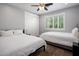 Comfortable bedroom featuring two beds, ceiling fan, and natural light from the window at 3401 N 34Th Pl, Phoenix, AZ 85018