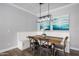 Cozy dining area featuring a built-in bench, wood table, and decorative lighting at 3401 N 34Th Pl, Phoenix, AZ 85018
