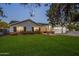 Charming single-Gathering home boasts an inviting entrance, a well-manicured front lawn and brick accents at 3401 N 34Th Pl, Phoenix, AZ 85018