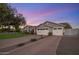Charming single-Gathering home boasts a spacious driveway and a well-manicured front lawn at dusk at 3401 N 34Th Pl, Phoenix, AZ 85018
