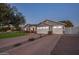 Charming single-Gathering home boasts a spacious driveway and a well-manicured front lawn at dusk at 3401 N 34Th Pl, Phoenix, AZ 85018