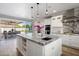 Gourmet kitchen with white cabinetry, stainless appliances, large marble island, and outdoor view at 3401 N 34Th Pl, Phoenix, AZ 85018