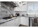 Kitchen features marble backsplash and counters, stainless appliances, and white cabinets at 3401 N 34Th Pl, Phoenix, AZ 85018