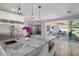 Kitchen island features marble countertops, built-in microwave, and stainless steel appliances at 3401 N 34Th Pl, Phoenix, AZ 85018