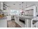Spacious kitchen with stainless appliances, marble counters, and a white island with seating at 3401 N 34Th Pl, Phoenix, AZ 85018