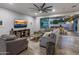 Spacious living room with modern decor, wood-look floors, comfortable seating, and access to an outdoor patio at 3401 N 34Th Pl, Phoenix, AZ 85018