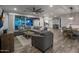Open-concept living room featuring wood-look flooring, a large sectional sofa, and seamless access to the backyard at 3401 N 34Th Pl, Phoenix, AZ 85018