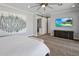 Spacious main bedroom with a large bed, ceiling fan and barn door to bath at 3401 N 34Th Pl, Phoenix, AZ 85018