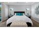 Bright main bedroom features a large bed, bench and many pillows at 3401 N 34Th Pl, Phoenix, AZ 85018