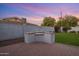 Outdoor kitchen featuring a built-in stainless steel grill on a brick patio with manicured grass in a fenced-in yard at 3401 N 34Th Pl, Phoenix, AZ 85018