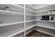 Walk-in pantry with custom shelves and hardwood floors at 3401 N 34Th Pl, Phoenix, AZ 85018