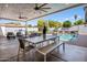 Inviting covered patio with ceiling fans, outdoor seating, dining table and view of the pool at 3401 N 34Th Pl, Phoenix, AZ 85018