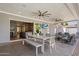 Inviting covered patio featuring a dining set, ceiling fans, and seamless indoor-outdoor living with a view to the backyard at 3401 N 34Th Pl, Phoenix, AZ 85018
