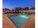 Inviting backyard pool featuring a waterfall feature, lounge chairs, and lush landscaping, perfect for relaxation at 3401 N 34Th Pl, Phoenix, AZ 85018