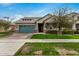 Charming single-Gathering home boasts a blue garage door, lush landscaping, and a welcoming entryway at 3485 E Silo Dr, Gilbert, AZ 85296