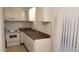 Well-lit kitchen featuring a stainless steel sink, white cabinetry, and modern appliances at 3526 W Dunlap Ave # 161, Phoenix, AZ 85051