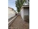 Backyard space with rock landscaping, block wall, and access gate at 3739 W Mission Ln, Phoenix, AZ 85051
