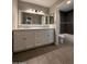 Bathroom with double sinks, granite countertops, and gray tile floors at 3739 W Mission Ln, Phoenix, AZ 85051