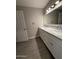 Bathroom featuring double vanity with granite countertops and gray tiled floors at 3739 W Mission Ln, Phoenix, AZ 85051