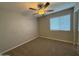 Bedroom featuring a ceiling fan, carpeted floors, and a bright window at 3739 W Mission Ln, Phoenix, AZ 85051