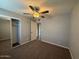Bedroom with ceiling fan, neutral walls, carpet, and mirrored closet doors at 3739 W Mission Ln, Phoenix, AZ 85051