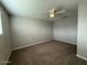 Neutral toned bedroom with carpeted floors and a ceiling fan at 3739 W Mission Ln, Phoenix, AZ 85051