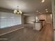 Dining area featuring modern light fixture and view into the kitchen at 3739 W Mission Ln, Phoenix, AZ 85051