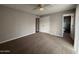 Spacious main bedroom featuring plush carpet, ceiling fan, and a private ensuite bathroom at 3739 W Mission Ln, Phoenix, AZ 85051