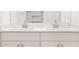 Bathroom features a double vanity with white cabinets and modern faucets at 3822 S 87Th Dr, Tolleson, AZ 85353