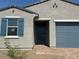 Close-up of the front of single-story home with blue accent colors at 3822 S 87Th Dr, Tolleson, AZ 85353