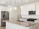 Bright kitchen with stainless steel appliances, granite countertops, and pendant lighting at 3822 S 87Th Dr, Tolleson, AZ 85353