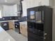 Bright kitchen featuring stainless steel appliances, two-tone cabinets and countertops at 38434 W Buckeye Rd, Tonopah, AZ 85354