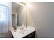 This bathroom features a sink with granite countertops and a mirror with accent lighting at 3948 W Kirkland Ave, Queen Creek, AZ 85142