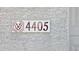 Close-up of the house number '4405' on a stucco wall with a decorative, modern sign at 4405 W Park St, Laveen, AZ 85339