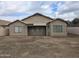 Rear view of home showing multiple windows and covered patio at 4405 W Park St, Laveen, AZ 85339