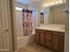 Bathroom featuring a bathtub and shower combination, vanity with wooden cabinets, and tiled flooring at 4405 W Park St, Laveen, AZ 85339