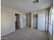 Spacious bedroom featuring neutral carpet, an expansive closet, and a view of the entryway and the yard at 4405 W Park St, Laveen, AZ 85339