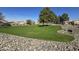 Beautiful community park featuring a large green lawn, mature trees, and Gathering recreation areas at 4405 W Park St, Laveen, AZ 85339