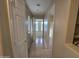 Hallway featuring tiled floors, neutral paint, and natural light streaming through windows at 4405 W Park St, Laveen, AZ 85339