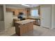 Functional kitchen with an island, oak cabinets, and stainless steel appliances at 4405 W Park St, Laveen, AZ 85339